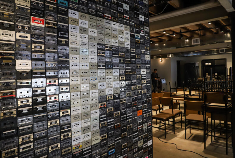 Friction's downtown Shawnee taproom is music themed, with a cassette tape mosaic near the entrance and sheet music wallpaper in the booths.
